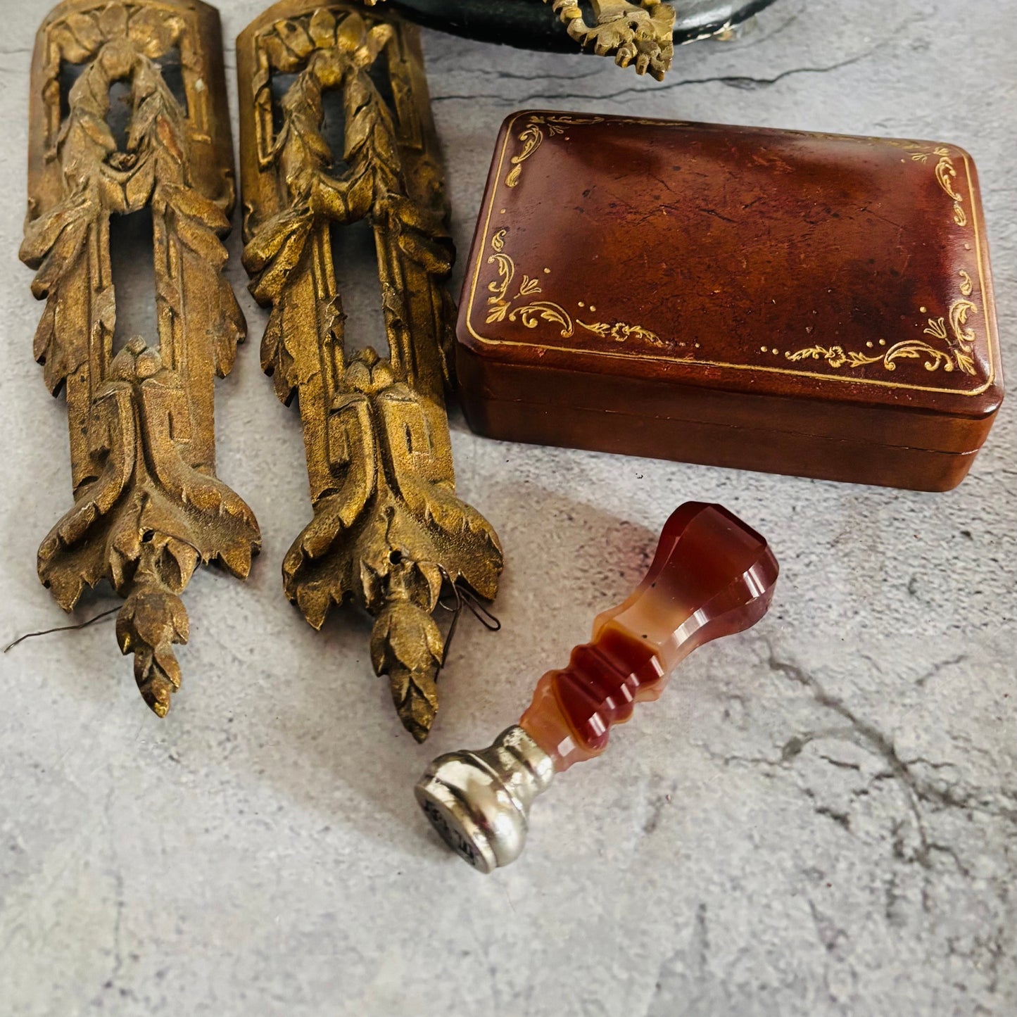 Antique Natural Agate Wax Seal Stamp, decorative brass pieces and a brown box on a textured surface