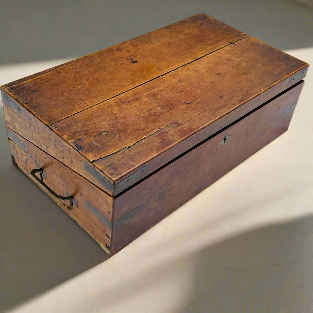 Vintage wooden box with a hinged lid on a neutral background