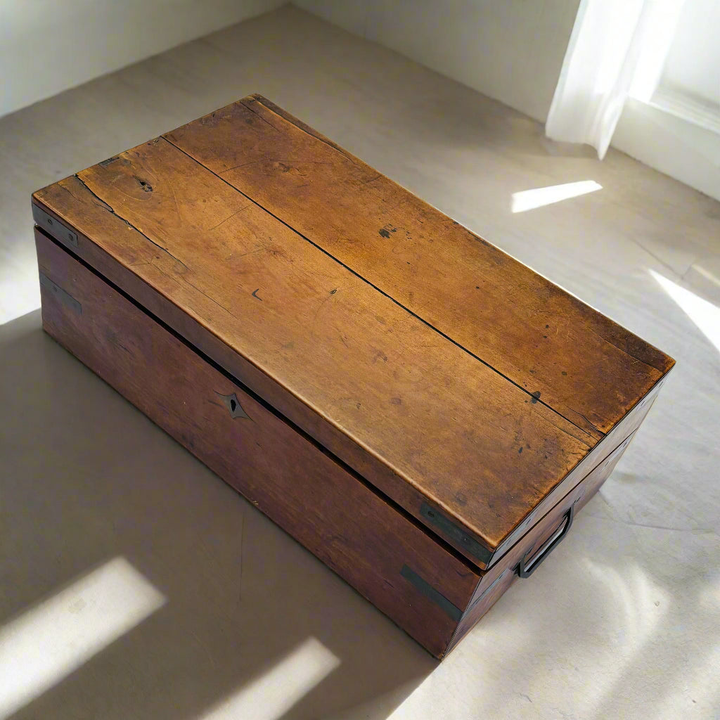 Wooden box on a white tablecloth with a wooden floor background