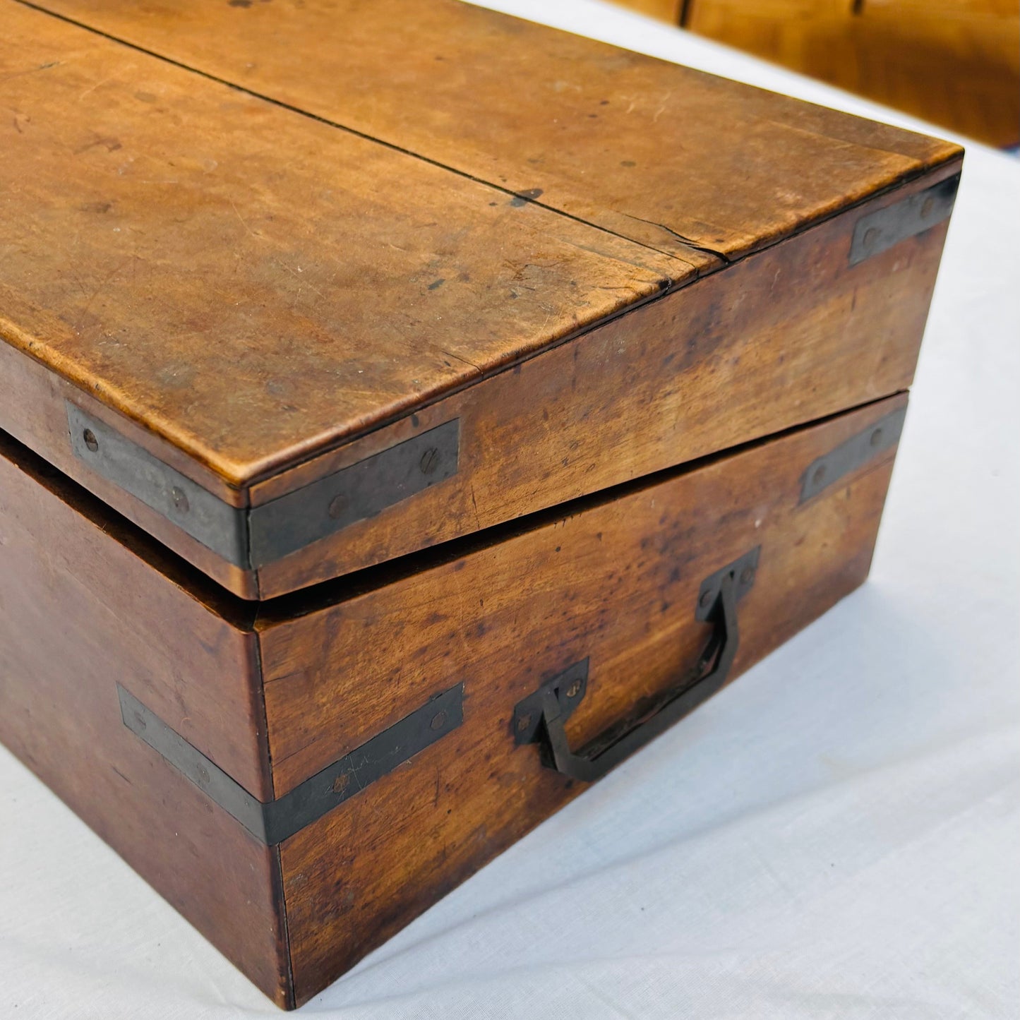 Wooden box with metal clasps on a white surface