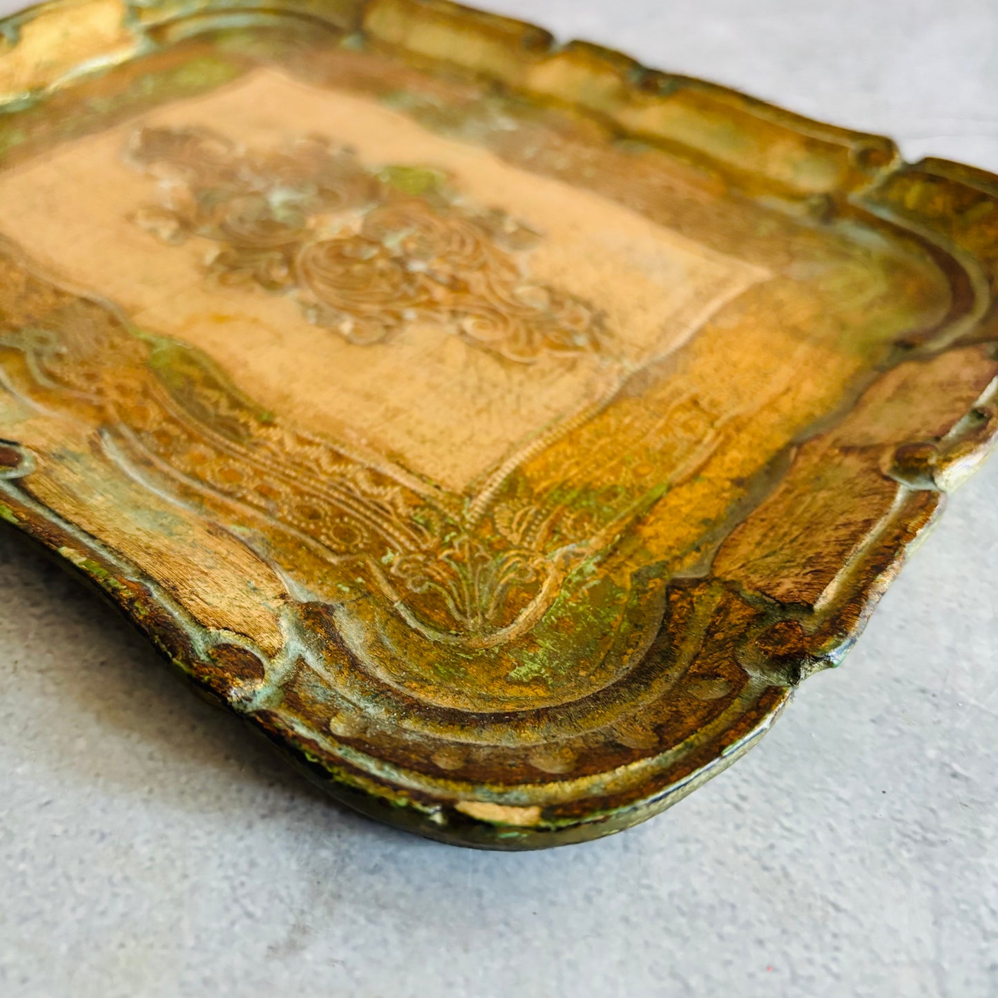 Decorative paper mache tray with intricate patterns on a light gray background