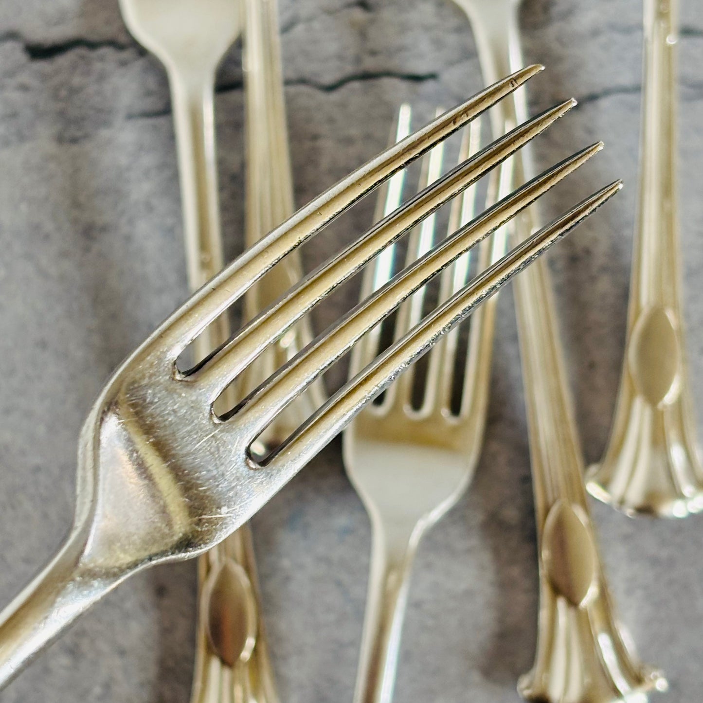 Close-up of silver forks on a textured surface