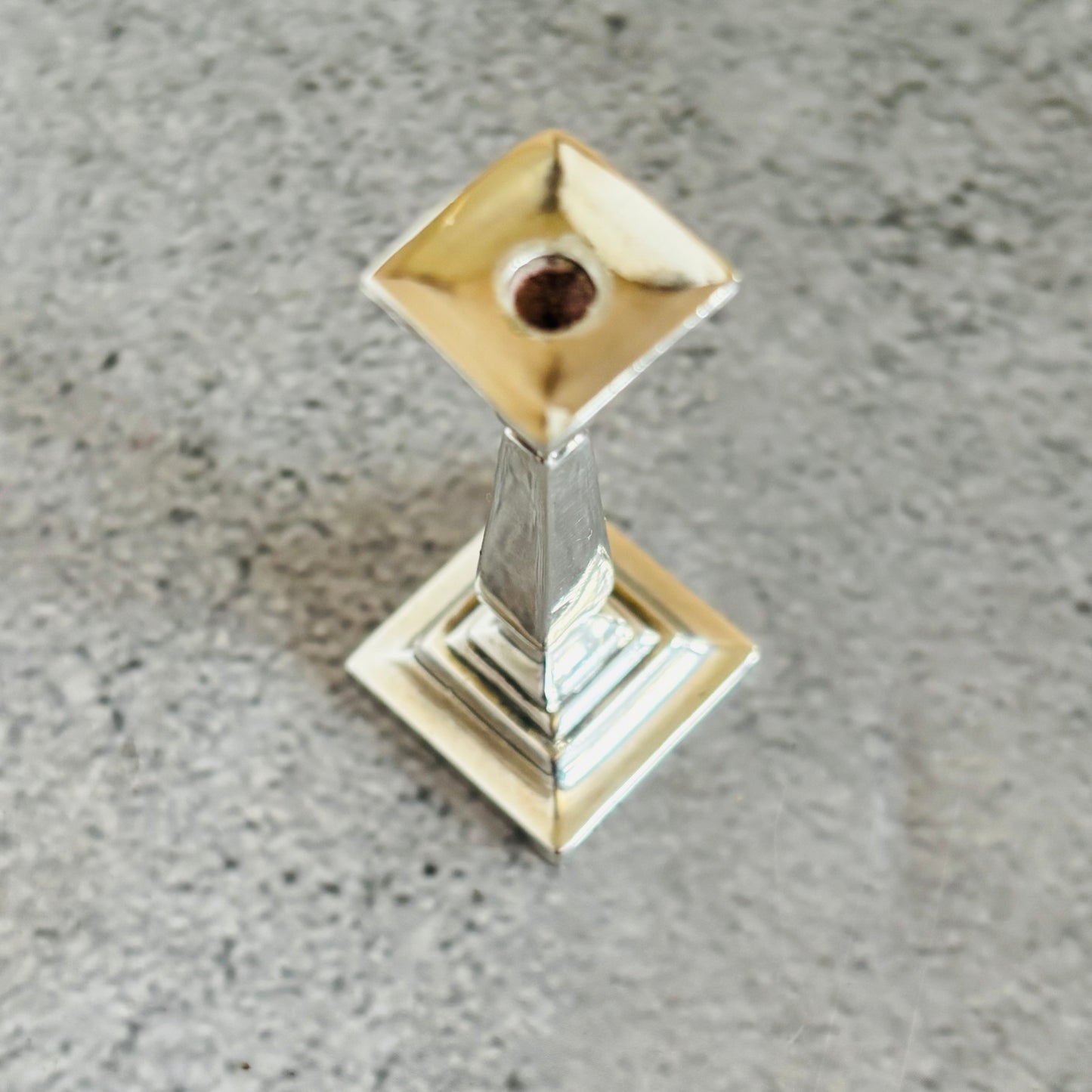 Decorative silver candle holder on a grey surface