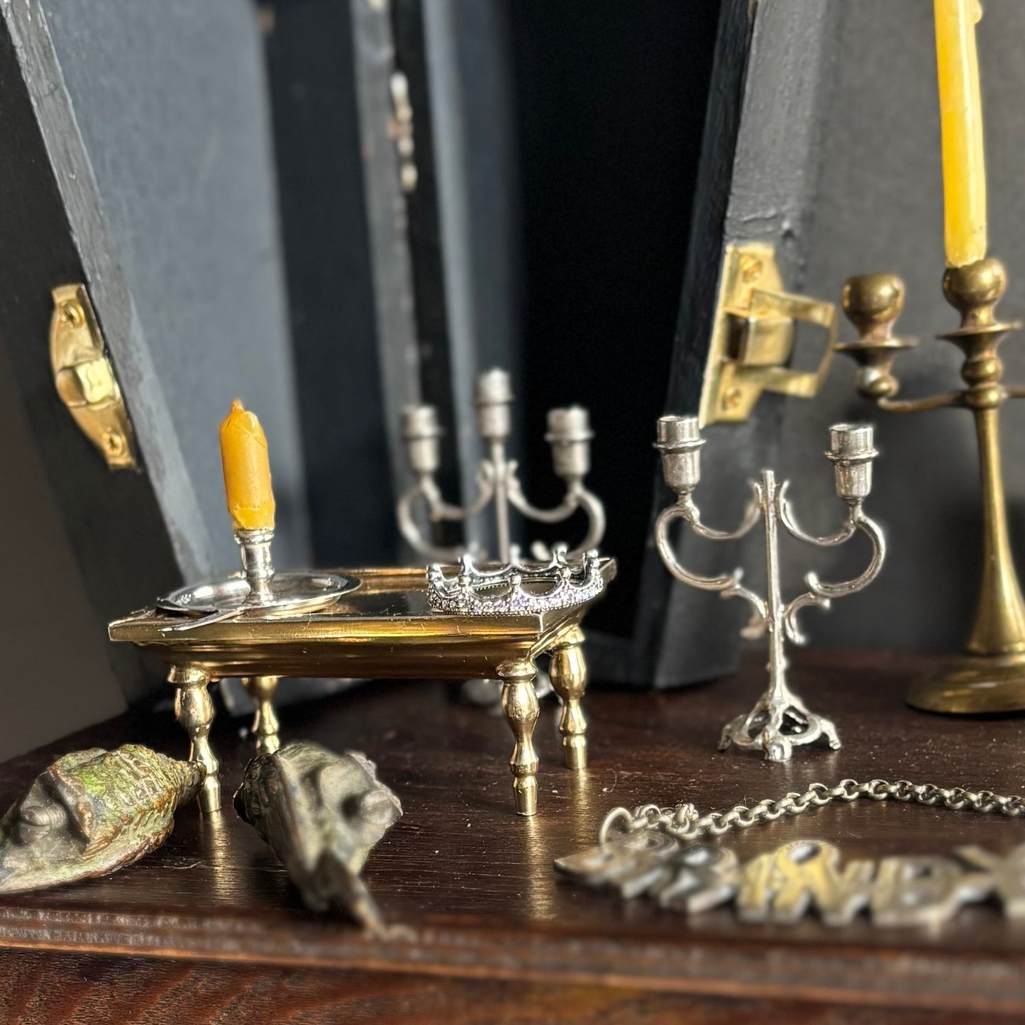 Collection of vintage-style candle holders and decorative items on a wooden surface.