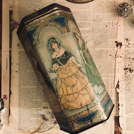 Decorative tin box with vintage illustration of a woman on an old newspaper background
