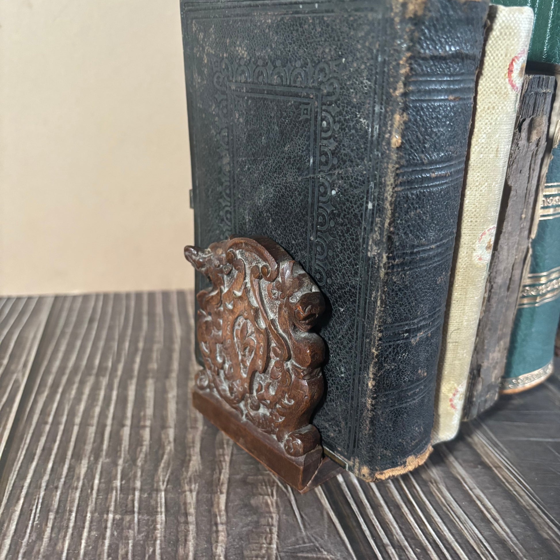 Vintage book with a decorative wooden end of a miniature Band Expanding Book Holder