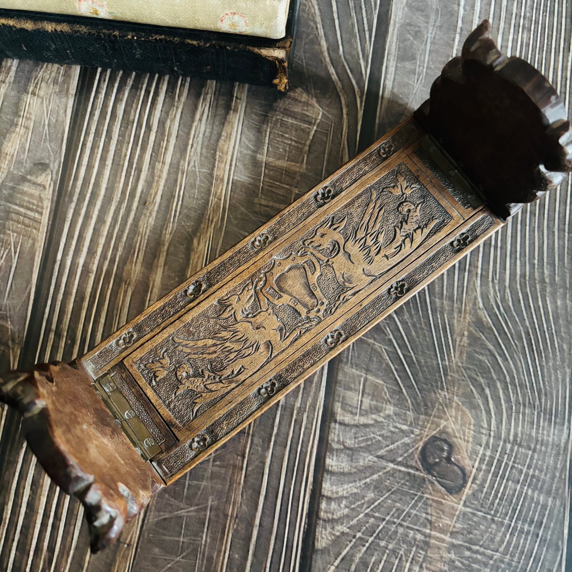 Miniature Book Slide with engraved design on a textured surface