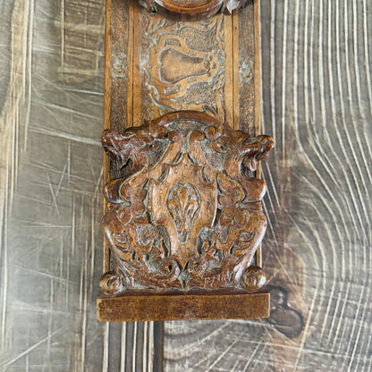 Decorative wooden panel with intricate carvings on a wooden surface