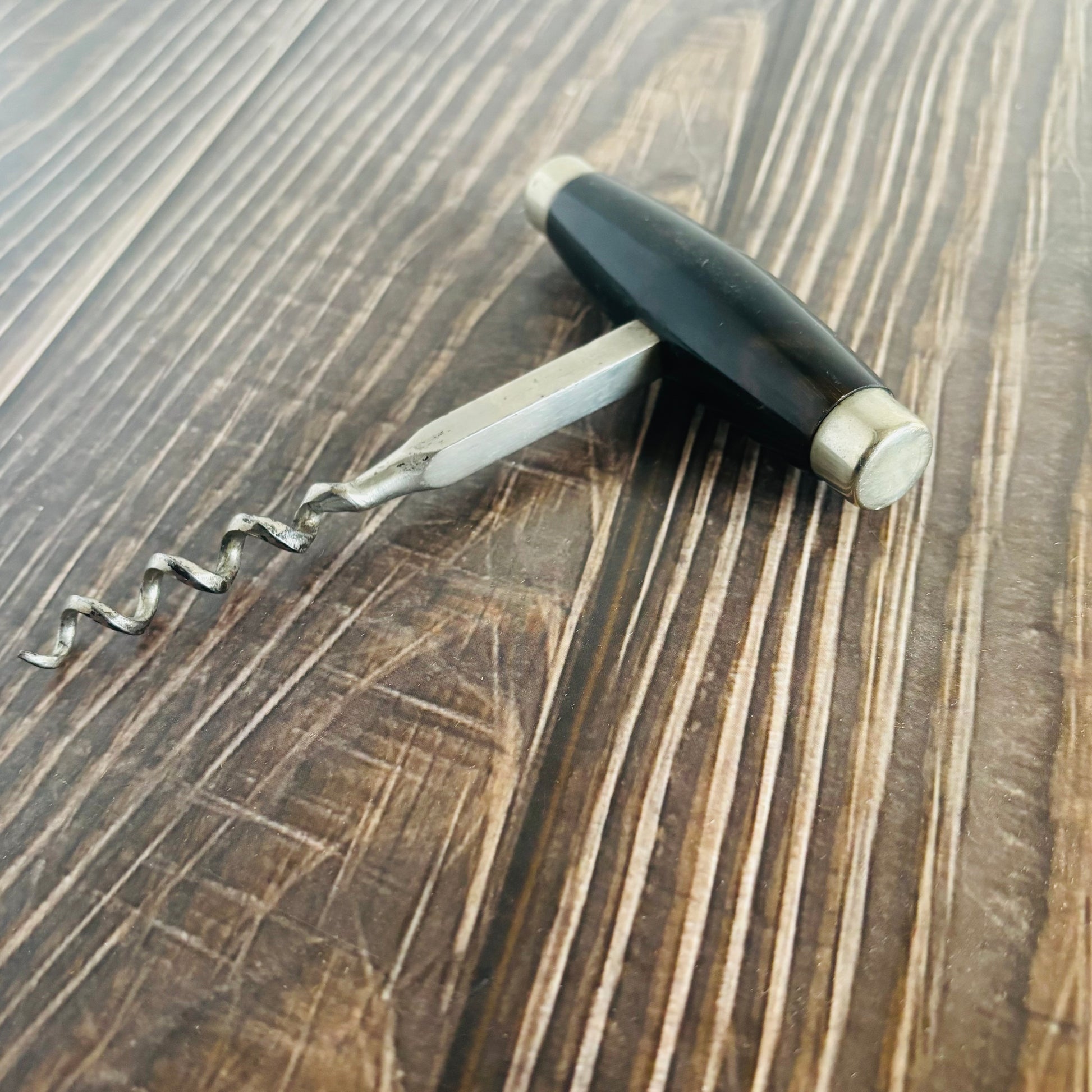 Corkscrew on a wooden surface