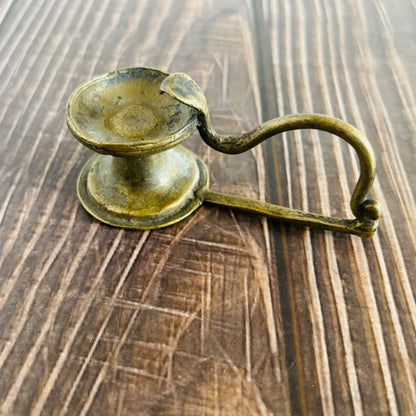 Bronze candle holder on a wooden surface