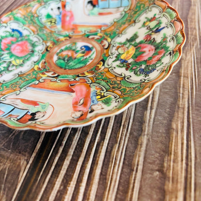 Decorative ceramic plate with colorful animal illustrations on a wooden surface