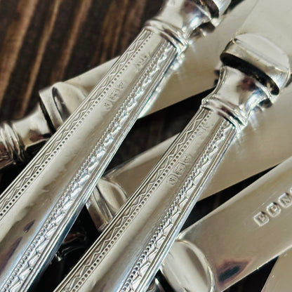 Close-up of silver handles with intricate designs on a dark background