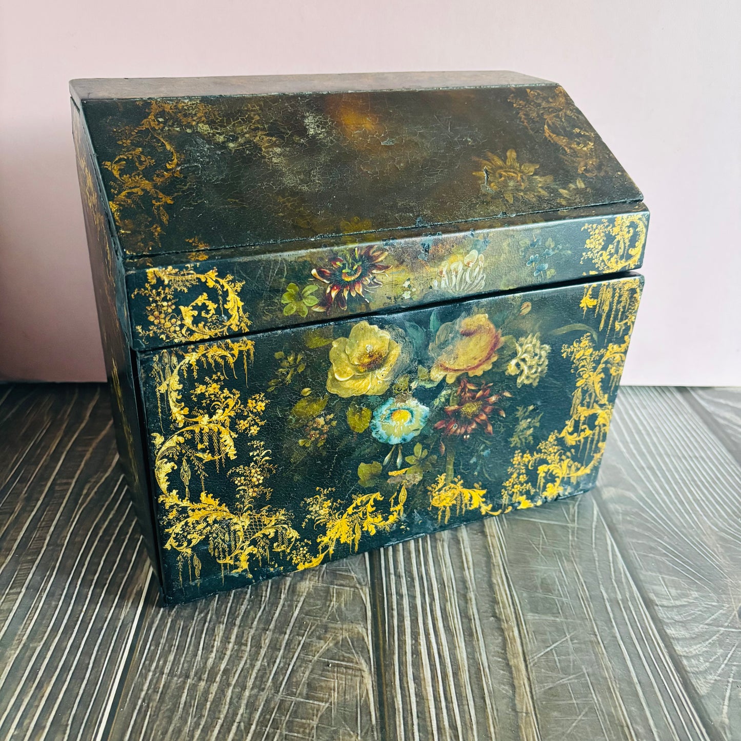 Victorian Paper Mache Lacquer Stationery Box  with hand painted floral patterns on a wooden surface