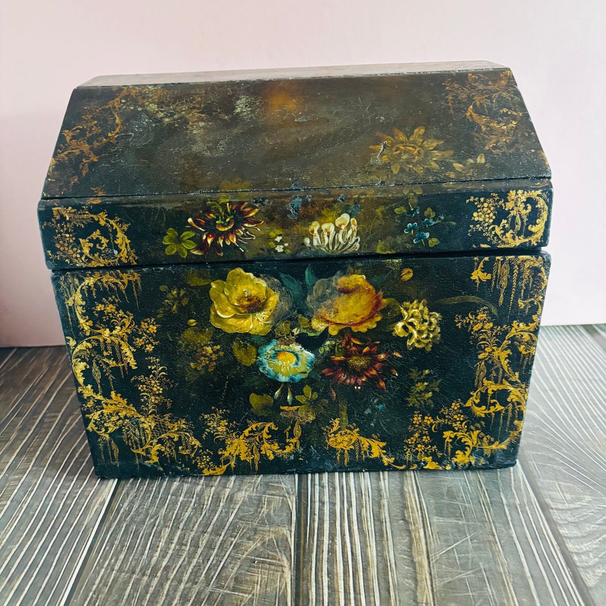 Victorian Paper Mache Lacquer Stationery Box  with hand painted floral patterns on a wooden surface