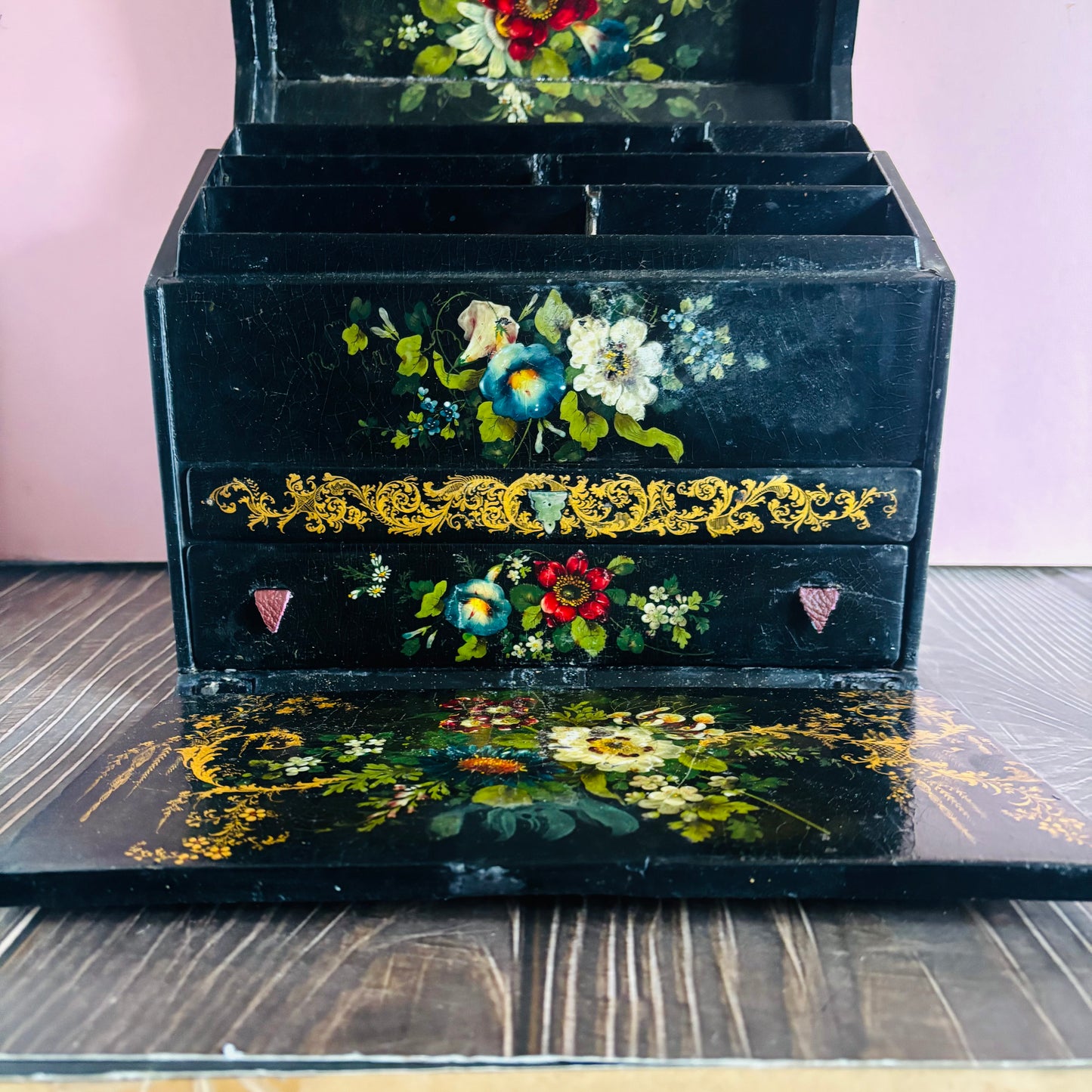 Victorian Paper Mache Lacquer Stationery Box  with hand painted floral patterns on a wooden surface