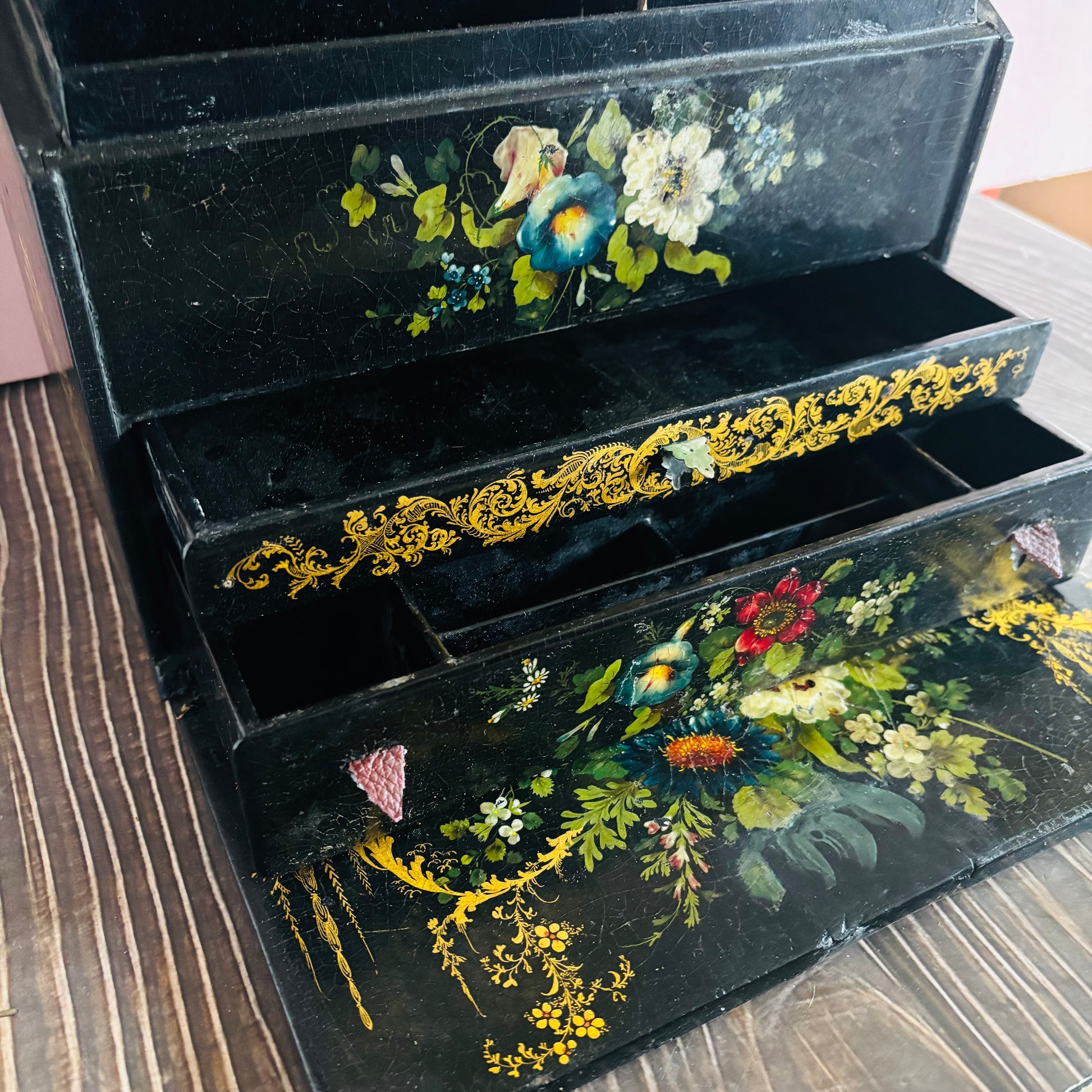 Victorian Paper Mache Lacquer Stationery Box  with hand painted floral patterns on a wooden surface