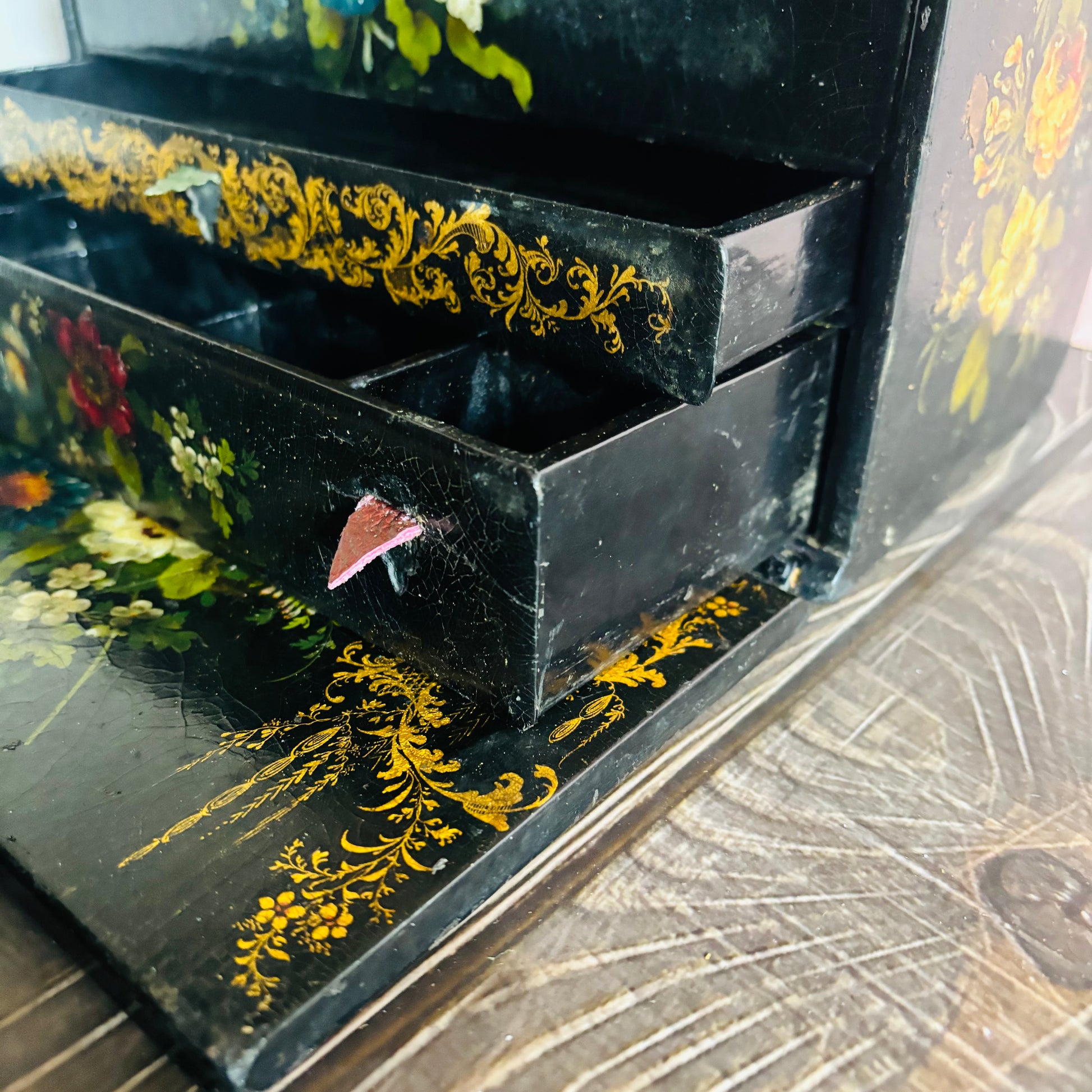 Victorian Paper Mache Lacquer Stationery Box  with hand painted floral patterns on a wooden surface