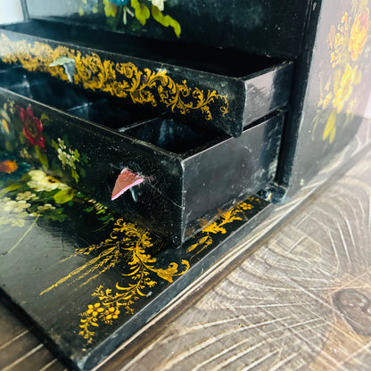 Victorian Paper Mache Lacquer Stationery Box  with hand painted floral patterns on a wooden surface