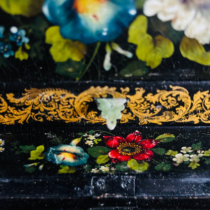 Victorian Paper Mache Lacquer Stationery Box  with hand painted floral patterns on a wooden surface