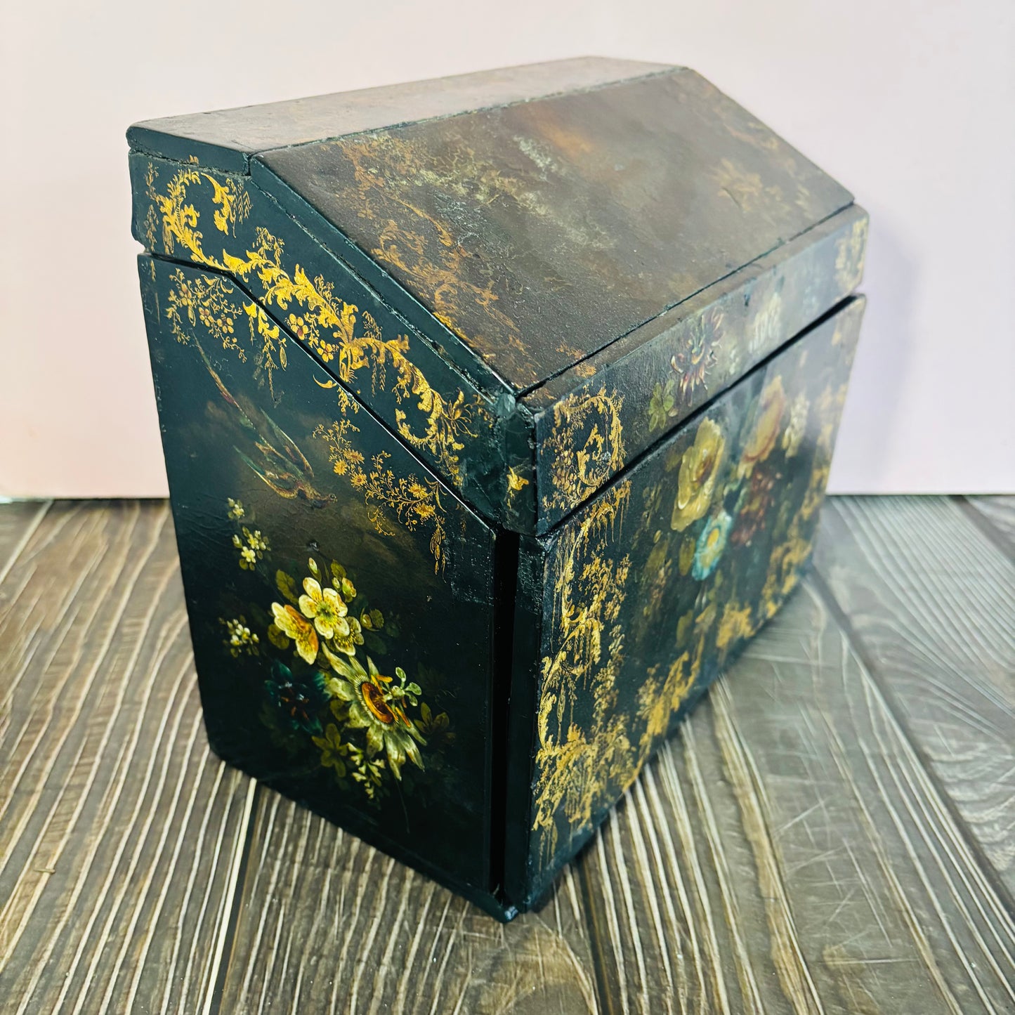Victorian Paper Mache Lacquer Stationery Box  with hand painted floral patterns on a wooden surface