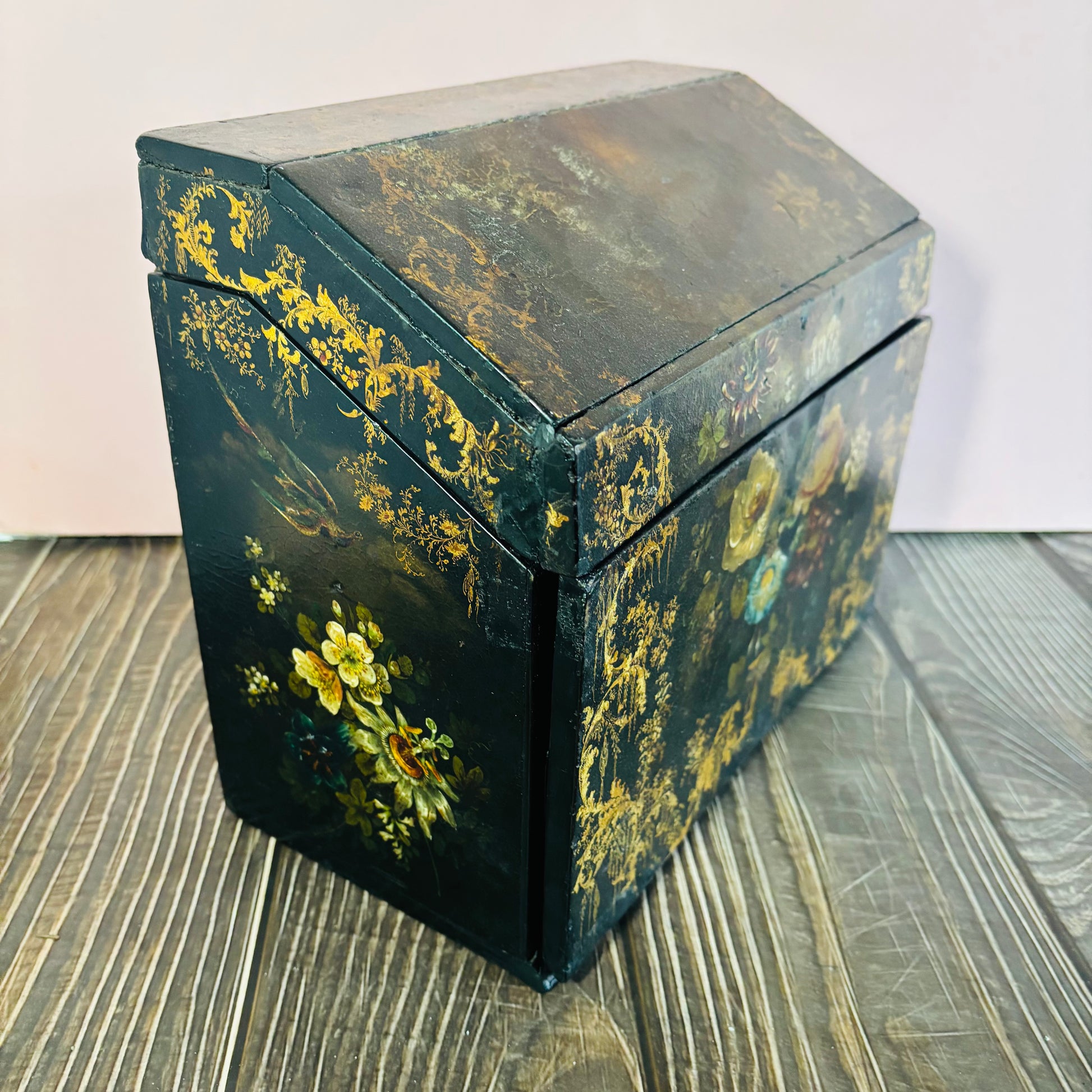 Victorian Paper Mache Lacquer Stationery Box  with hand painted floral patterns on a wooden surface
