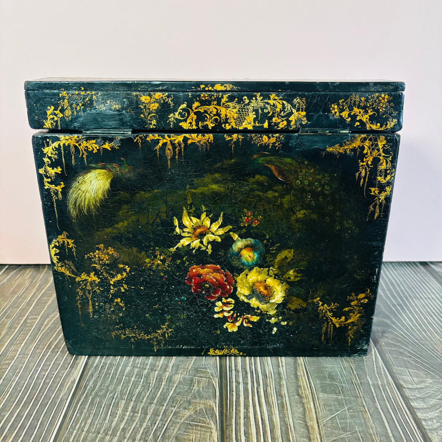 Victorian Paper Mache Lacquer Stationery Box  with hand painted floral patterns on a wooden surface