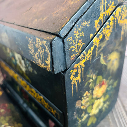 Victorian Paper Mache Lacquer Stationery Box  with hand painted floral patterns on a wooden surface
