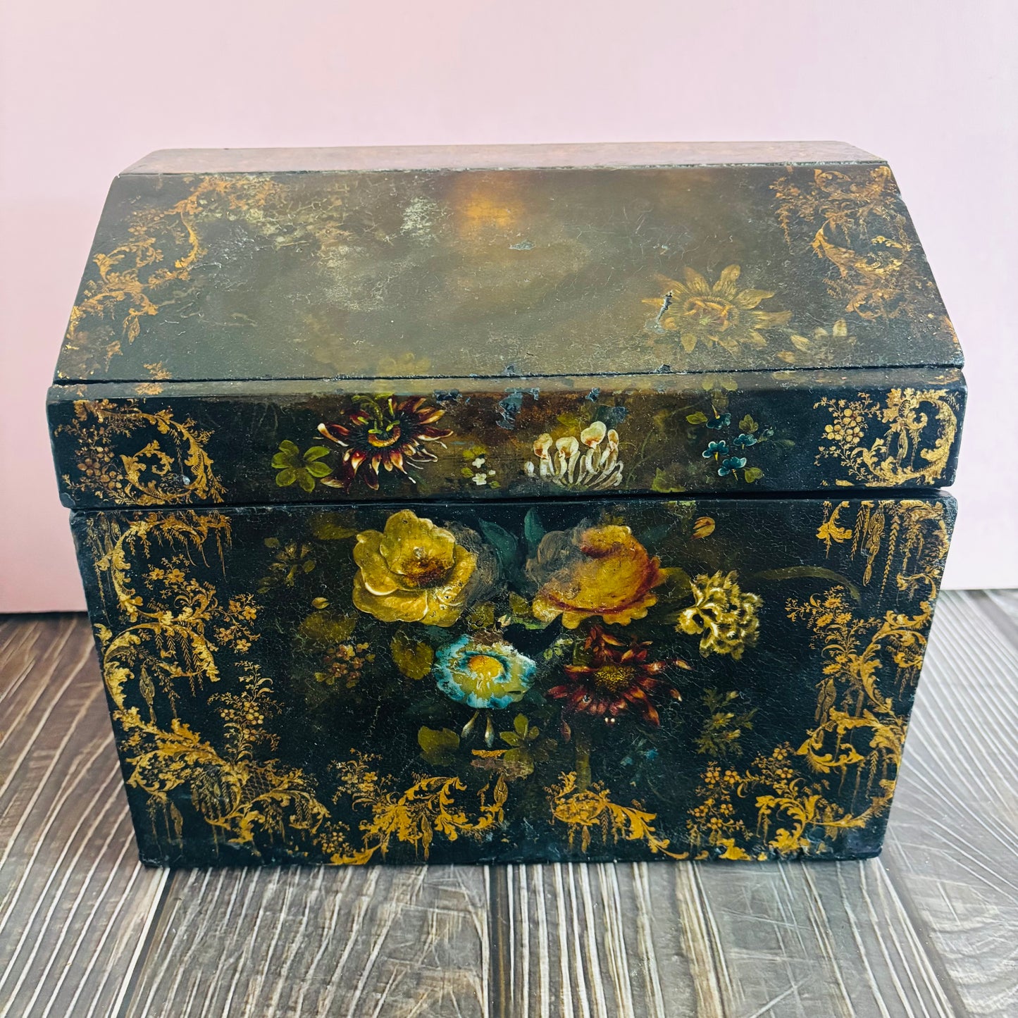 Victorian Paper Mache Lacquer Stationery Box  with hand painted floral patterns on a wooden surface
