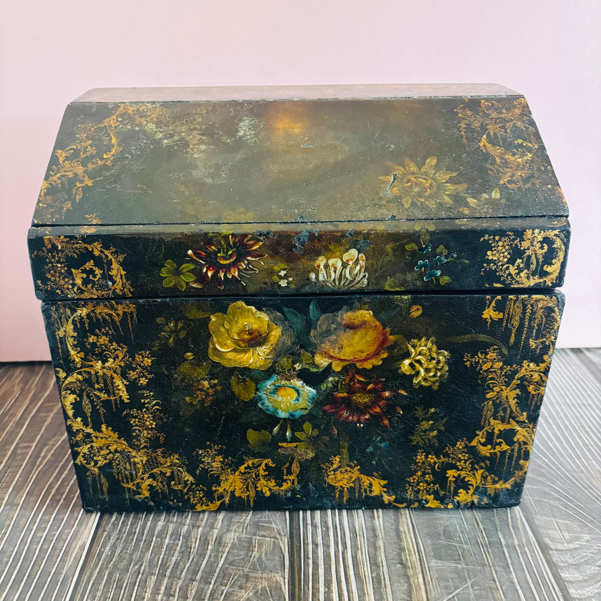 Victorian Paper Mache Lacquer Stationery Box  with hand painted floral patterns on a wooden surface