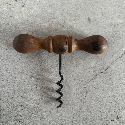 Wooden corkscrew on a concrete surface