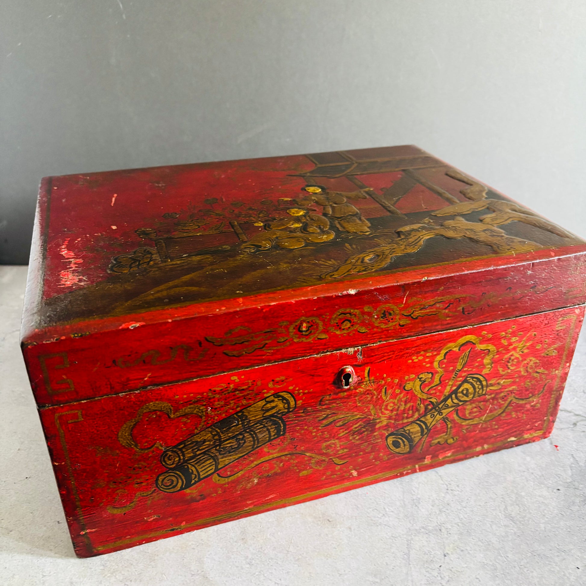 Red wooden box with gold decorative elements on a white background