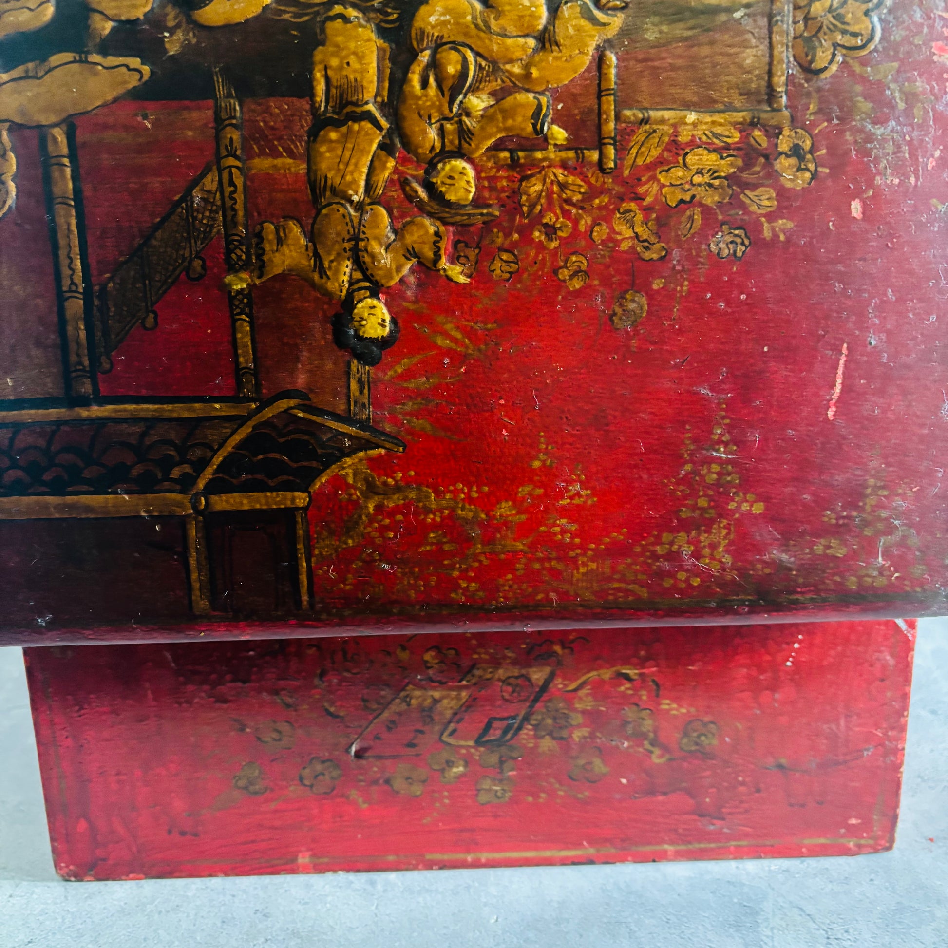 Decorative wooden box with intricate painting and red background