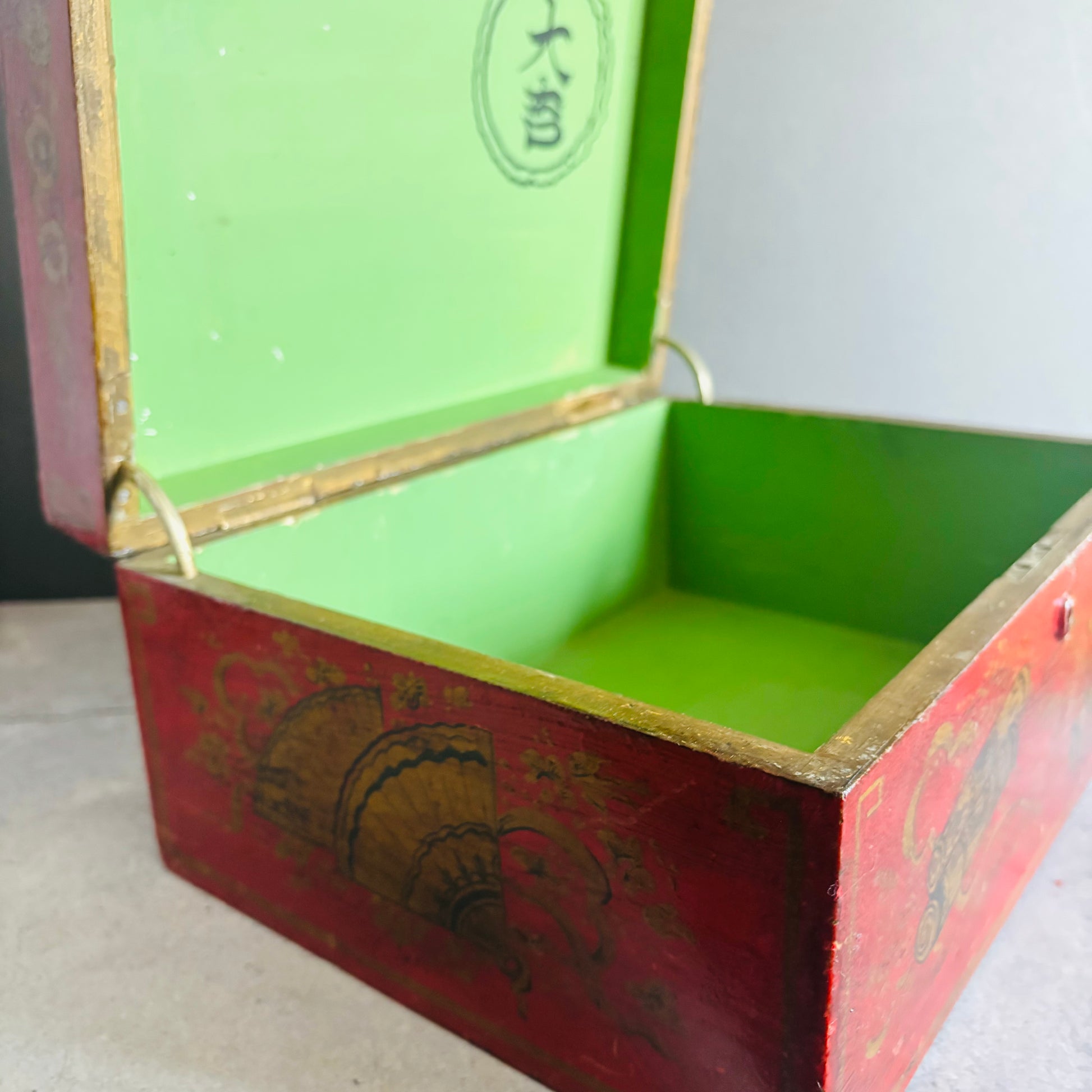 Open red and green tea box with a white background