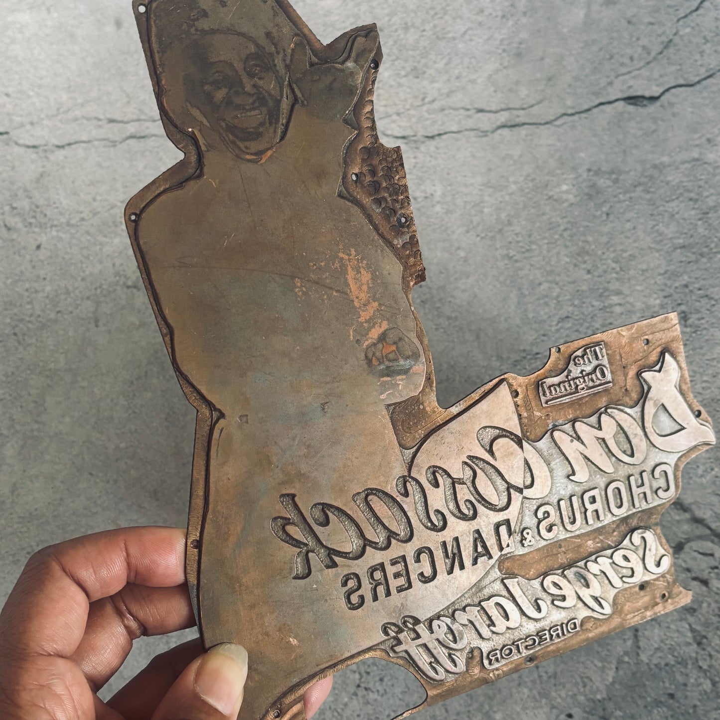 antique copper printing plate on a grey background