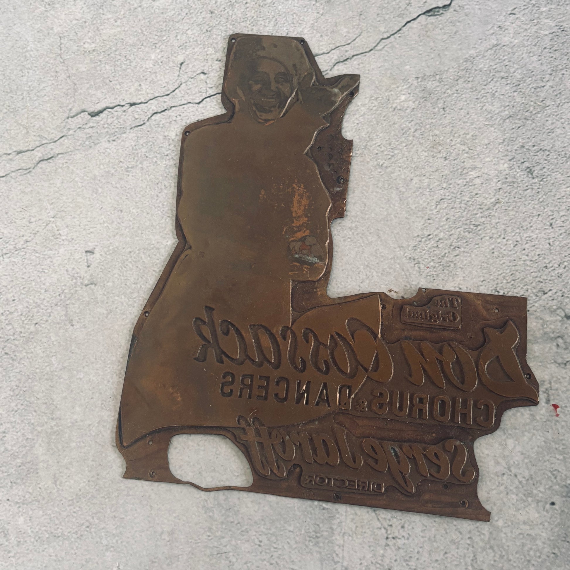 antique copper printing plate on a grey background
