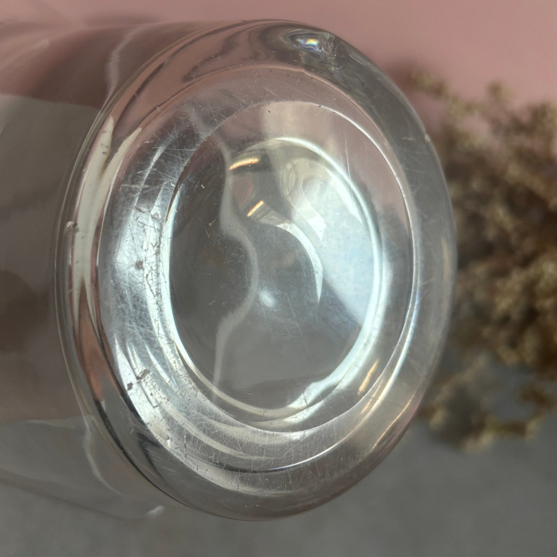 Close-up of a glass base on a pink background