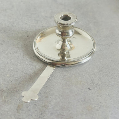 Antique Silver miniature candlestick holder trimmer on a grey background