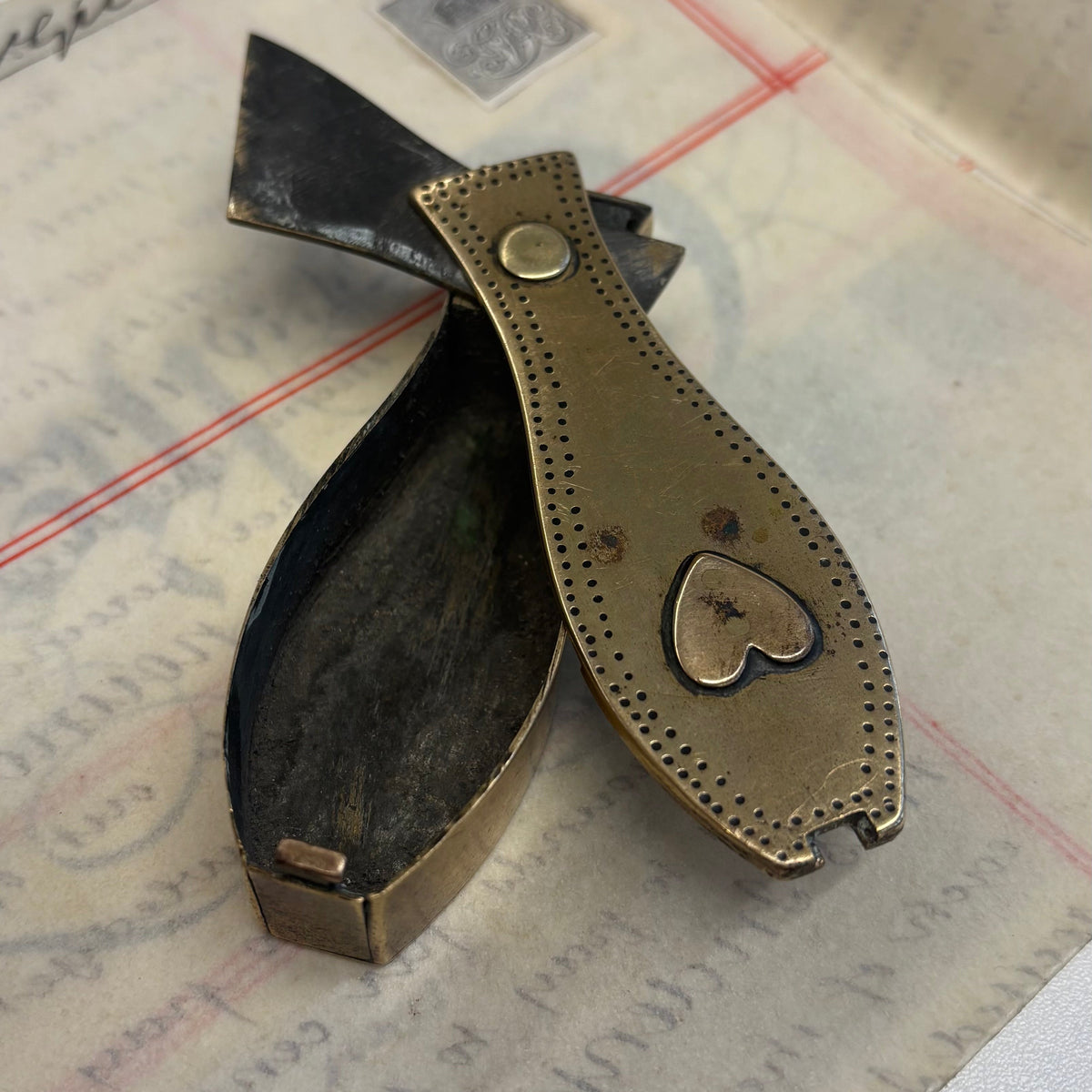 Antique Brass Dutch Coffin Puzzle Snuff Box | Rare Collectors piece resting on a piece of aged, stamped paper.