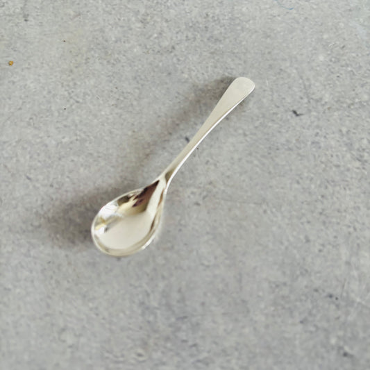 Silver spoon on a gray surface