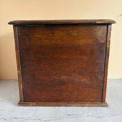 Dark wooden cabinet against a beige wall
