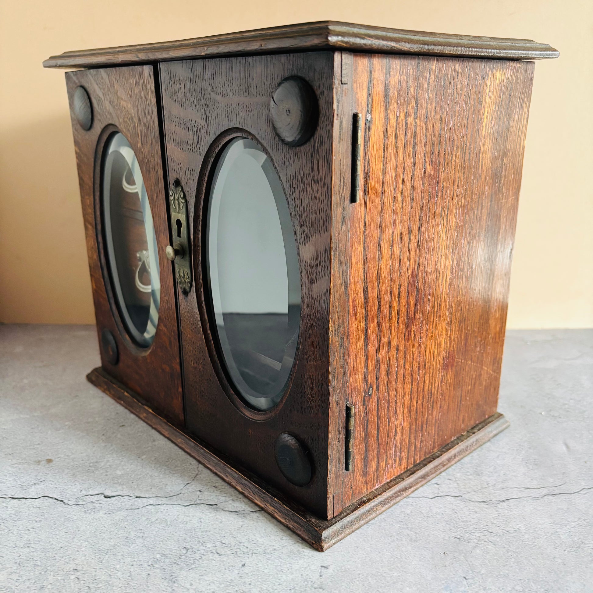 Wooden cabinet with glass doors on a concrete floor