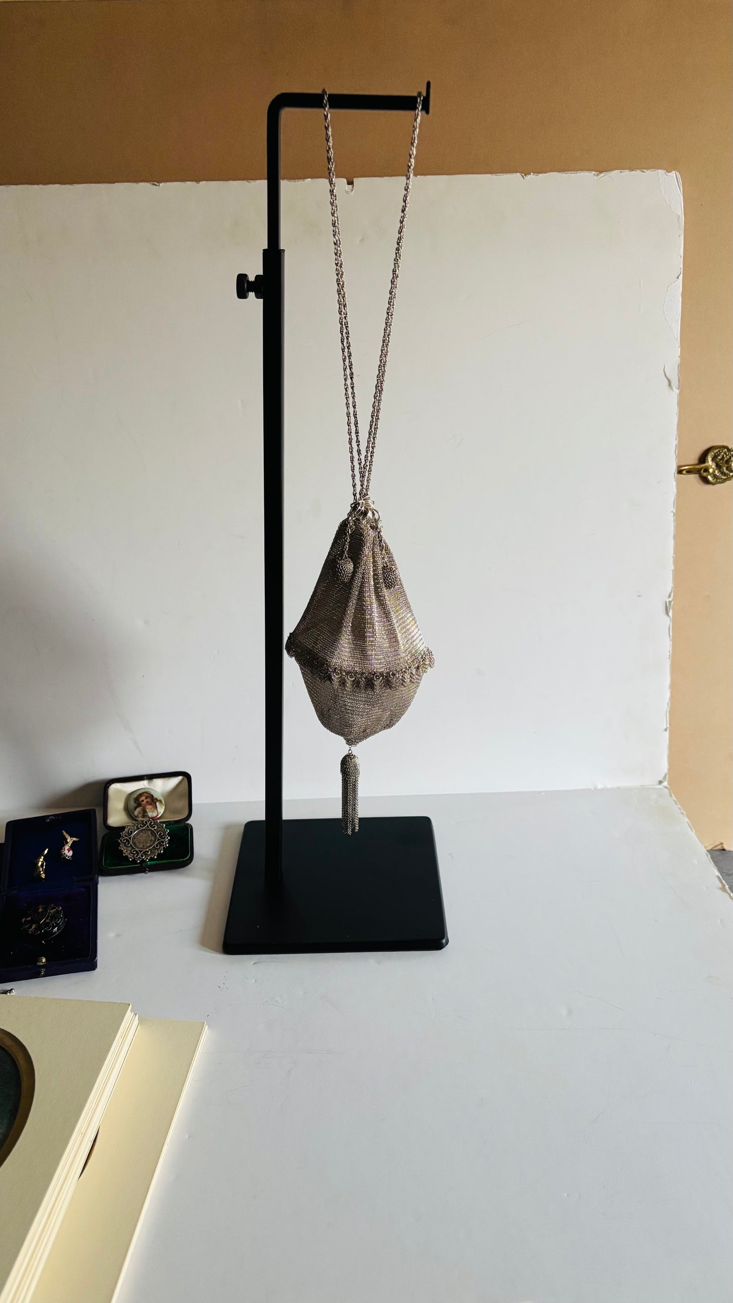 Silver Chainmail Pouch Bag on a stand against a white background