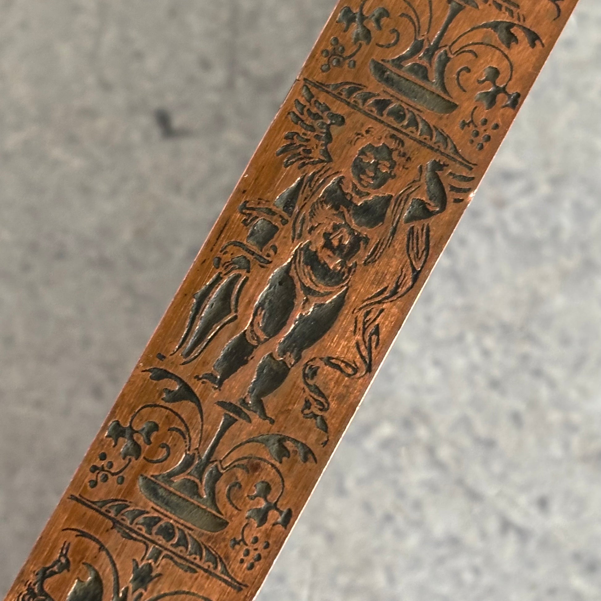 Decorative Antique Copper Printing Block Etched with intricate carvings on a grey surface
