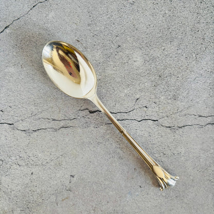 Silver spoon on a textured grey surface