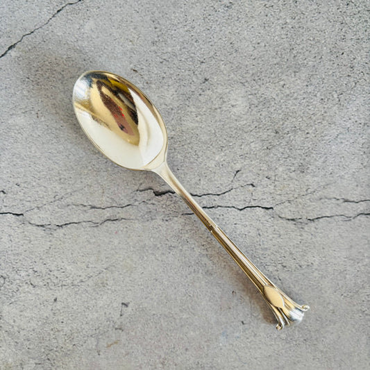 Silver spoon on a textured grey surface