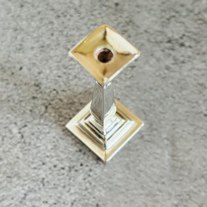 Decorative silver candle holder on a grey surface