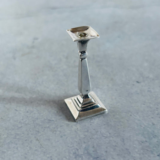 Antique Silver Miniature candle holder on a grey surface