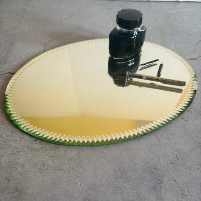 Antique Oval Sorcerers Mirror Mat | Gypsy Mirror Display Plateau with a bottle and tools on a concrete surface