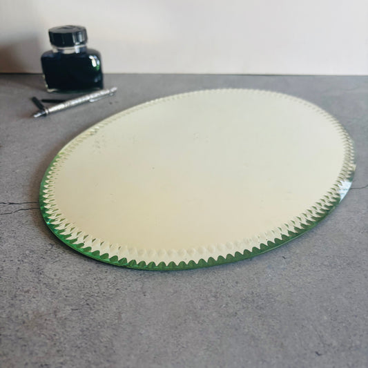 Antique Oval Sorcerers Mirror Mat with ink bottle and pen in the background.