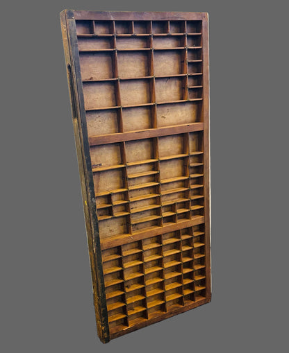 Wooden type tray with compartments on a gray background